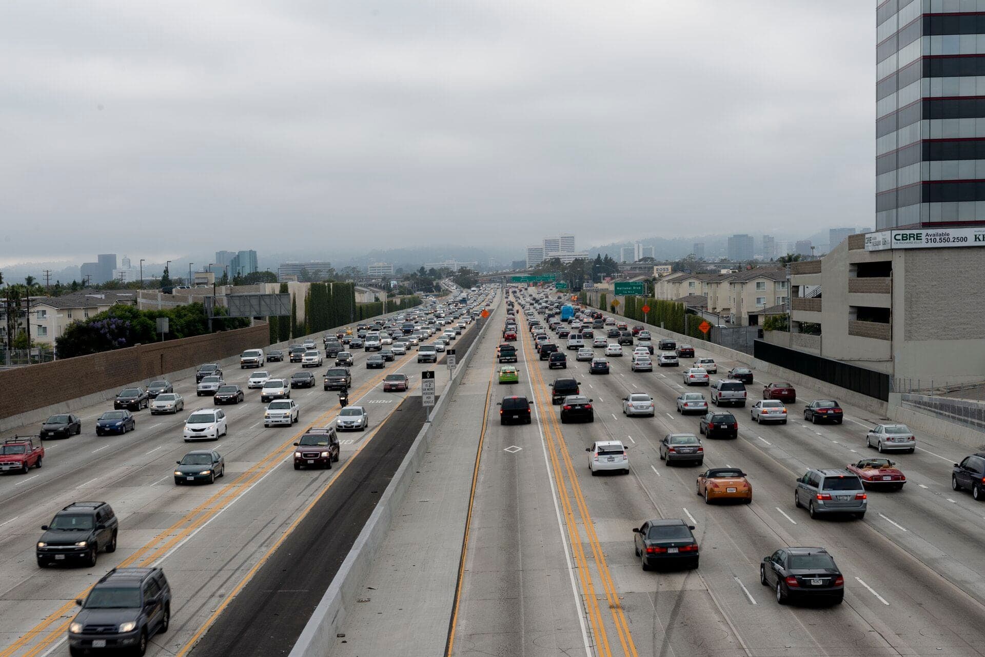 Heavy traffic on Interstate 405 in Los Angeles beneath an overcast sky