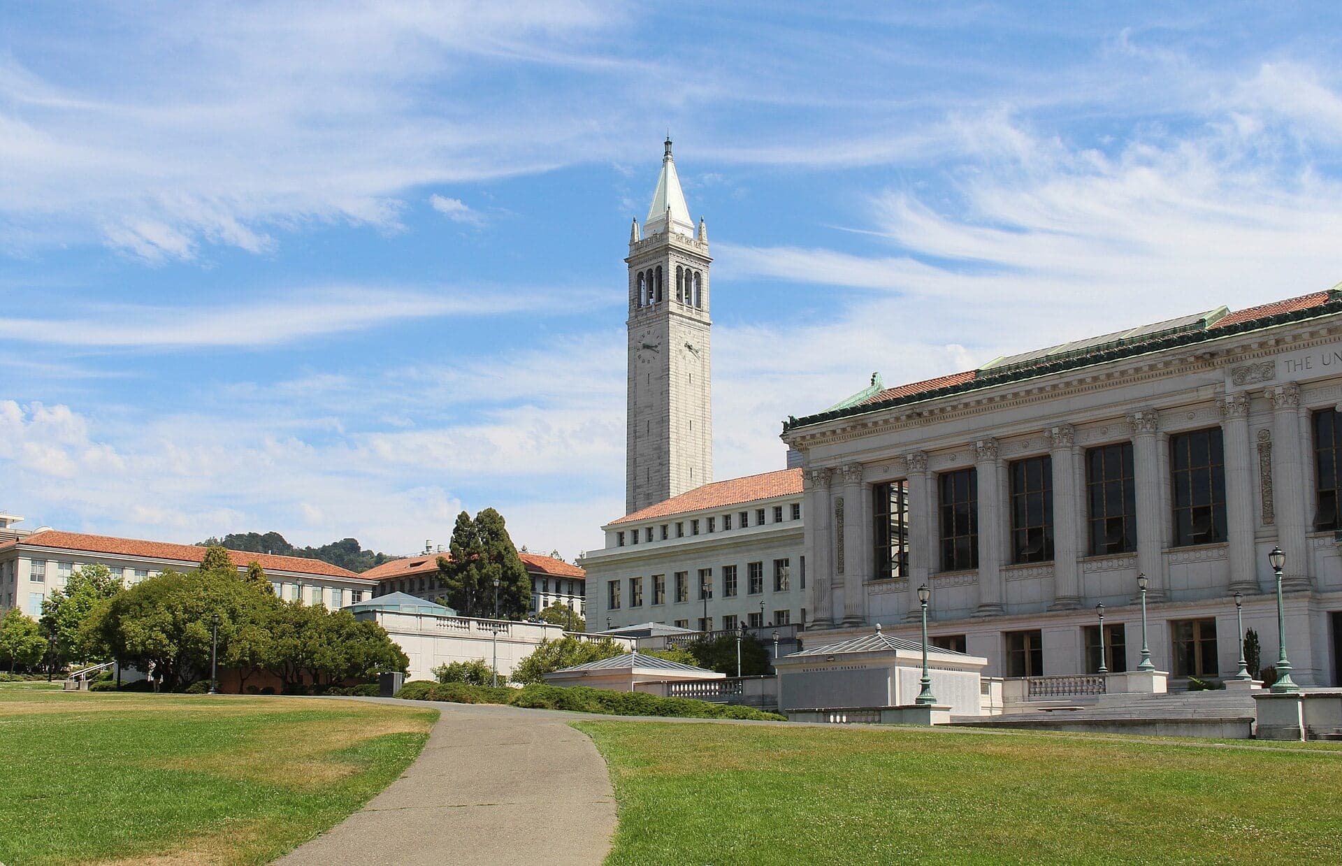 Sather Tower, the Campanile, rising above the University of California, Berkeley, seen across Memorial Glade, with Doe Library at right