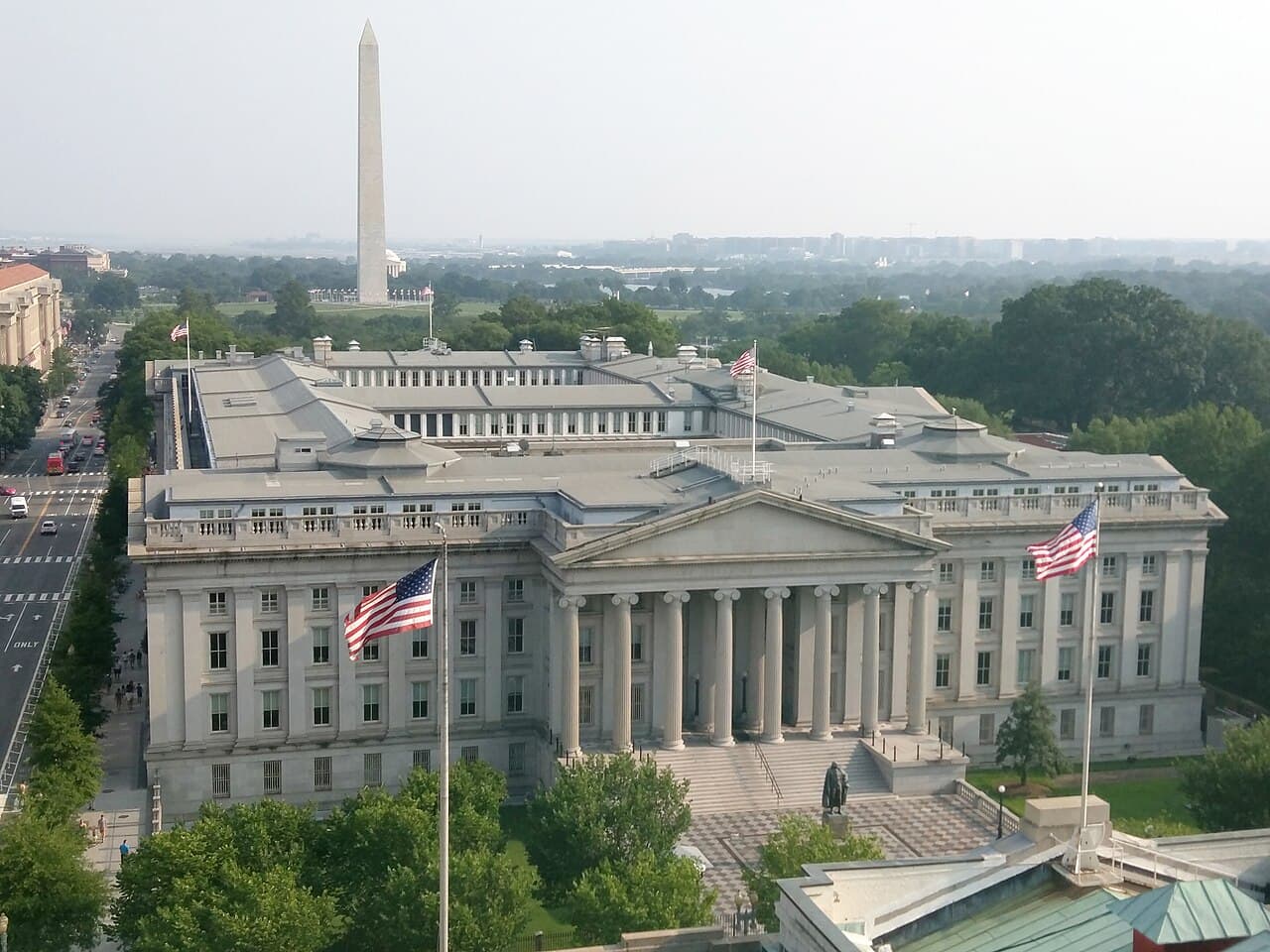 The United States Treasury Building in Washington, with the Washington Monument beyond