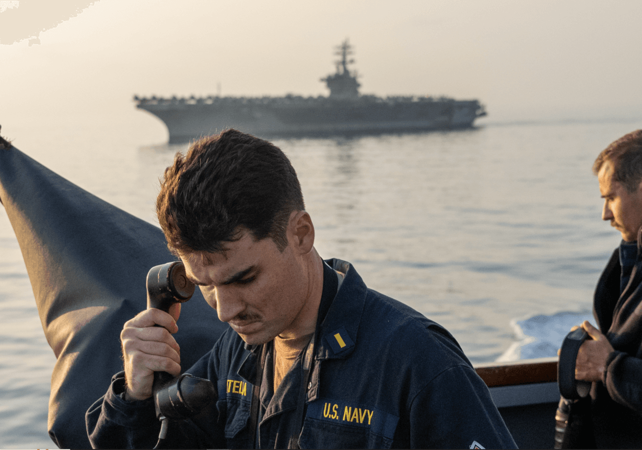 A sailor relays information aboard the guided-missile destroyer USS Mason in the Red Sea