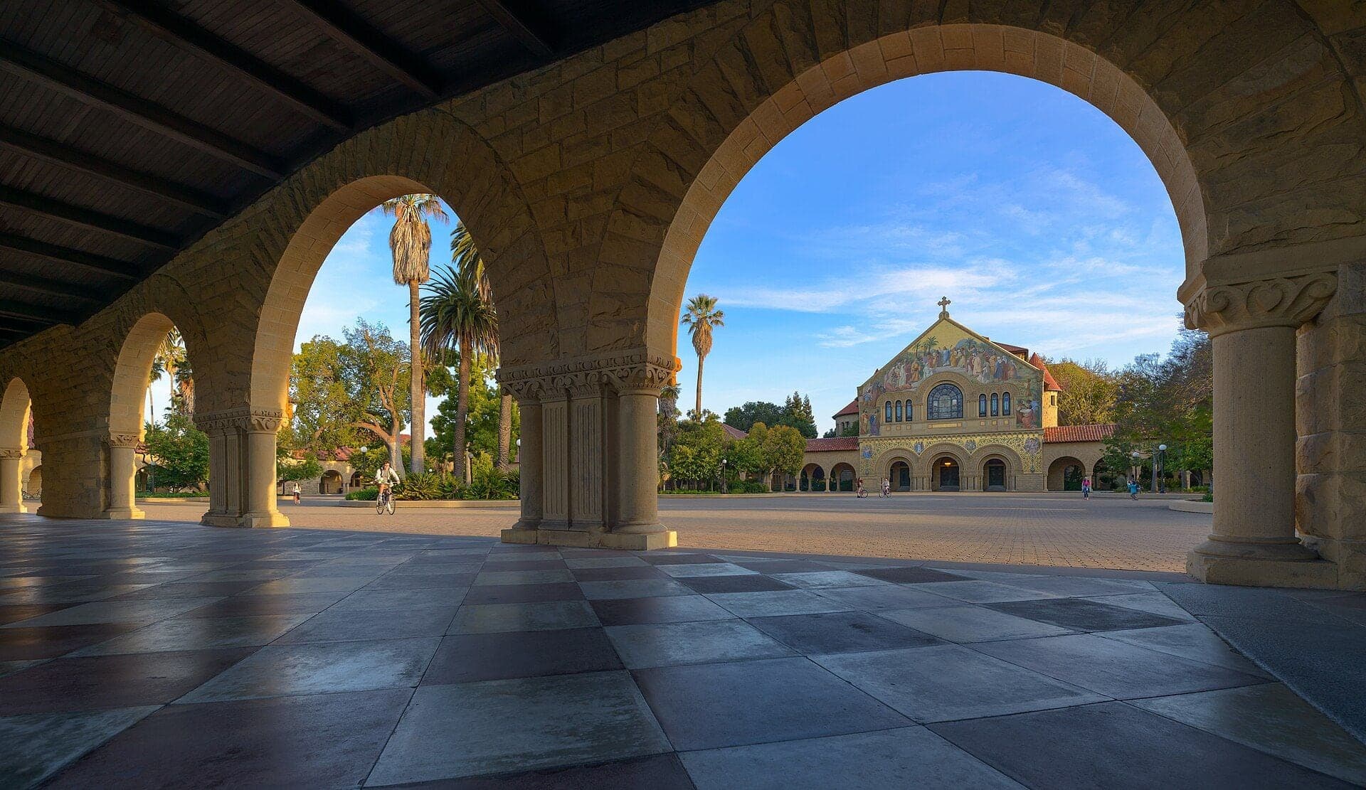 The sandstone arcade of Stanford University's Main Quad, with Memorial Church beyond