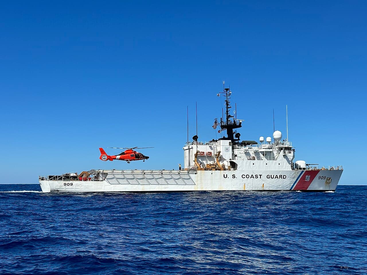 A Coast Guard helicopter landing on the flight deck of the cutter Campbell at sea